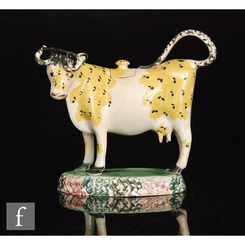 A late 18th to early 20th Century cow creamer and cover, pos...