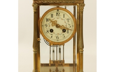 A late 19th century brass four glass mantel clock - the circ...
