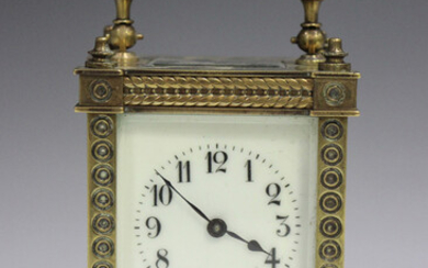 A late 19th/early 20 century lacquered brass carriage timepiece with eight day movement, the dial wi