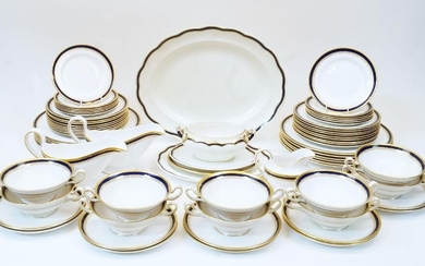 A modern Spode porcelain part dinner service, designed with gilt and cobalt blue borders, comprising: two gravy boats, one with saucer, twelve dinner plates, eighteen medium plates, ten twin handled soup bowls with ten saucers, twelve side plates...