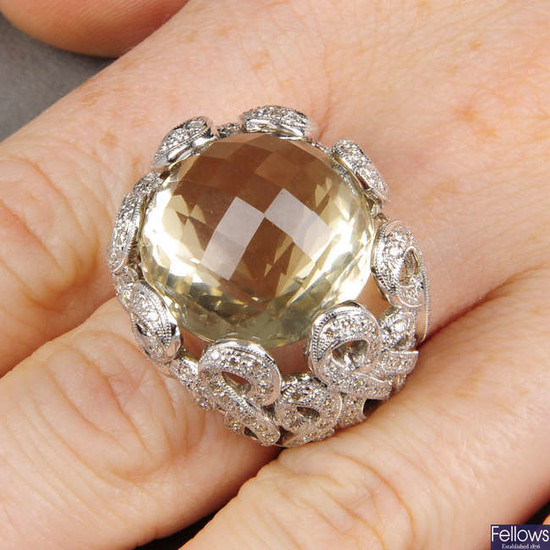 A multifaceted citrine dress ring, with diamond