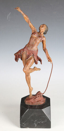 A painted cast spelter figure of an Amazonian female, holding a long strand of vine, mounted on a bl