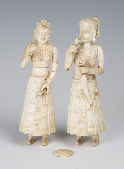A pair of 19th century Indian carved ivory full-length figures of a lady and gentleman, height 18cm