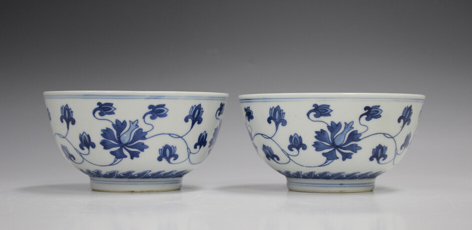 A pair of Chinese blue and white porcelain bowls, mark of Kangxi but 20th century, each painted with