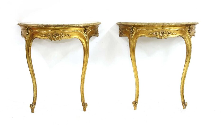 A pair of giltwood demi-lune marble topped console tables