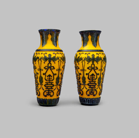 A pair of yellow-glass vases overlaid with dark lavender glass