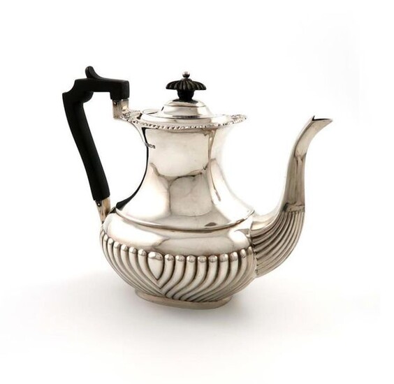 A silver coffee pot, by H. Atkins, Sheffield 1911, oblong bellied form, part-fluted decoration, scroll handle, foliate and gadroon border, height 18cm, approx. weight 14.5oz.