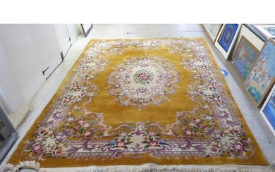 A traditional 20thC Chinese washed woollen carpet, decorated...