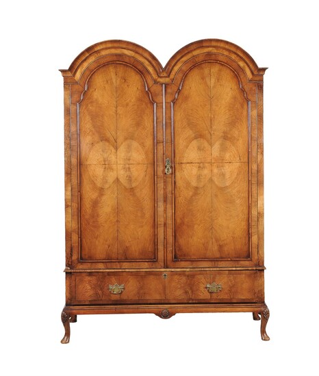 A walnut double domed wardrobe in early 18th century style