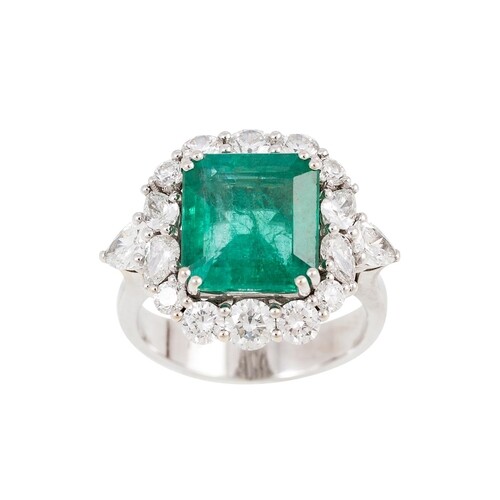 AN EMERALD AND DIAMOND CLUSTER RING, the octagonal emerald t...