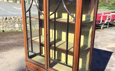 An Edwardian satinwood banded mahogany display cabinet with moulded cornice...