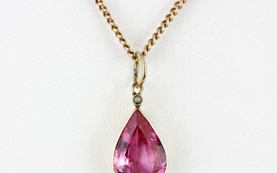 An antique yellow metal (tested minimum 9ct gold) pendant set with a large pear cut pink sapphire and seed pearl, L. 2.5cm, on a 9ct gold ch