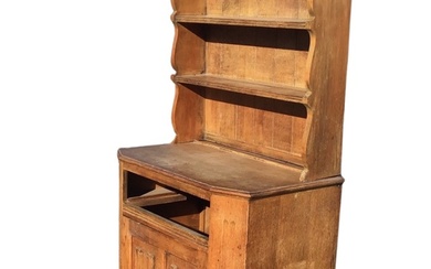 An oak dresser with moulded cornice and shaped apron above...