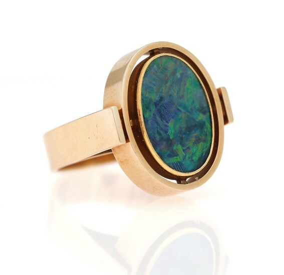 SOLD. An opal ring set with an polished opal, mounted in 14k gold. Size app....