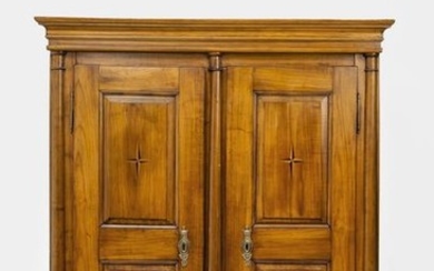 Biedermeier cupboard. Walnut. Body divided by three half-columns,...