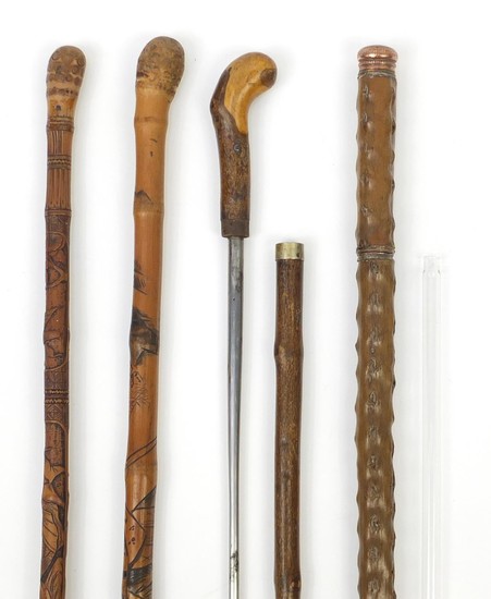 Four walking sticks comprising two Chinese carved bamboo exa...