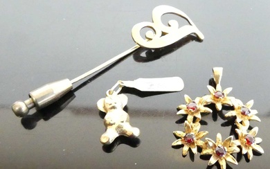 Lot details A yellow metal garnet set flower head pendant,...