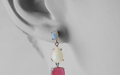 Pair of silver earrings adorned with two cabochon opals, one of which is piriform supporting a faceted oval ruby.