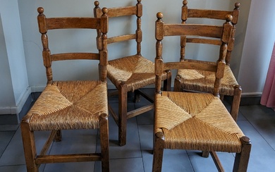 Suite de quatre chaises en bois naturel, l'assise paillée. H. 94 cm. On joint une...