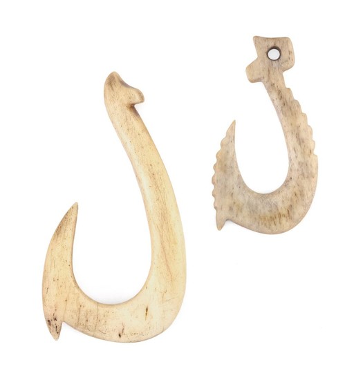 TWO PACIFIC ISLANDS CARVED BONE FISH HOOKS One with serrated barb and pierced hole. Lengths 2.25" and 3". This item is not available...