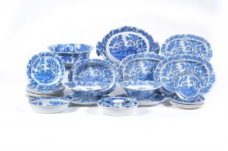 The remnants of a Henshall & Co. blue and white printed pearlware 'Castle & Bridge' pattern dinner service