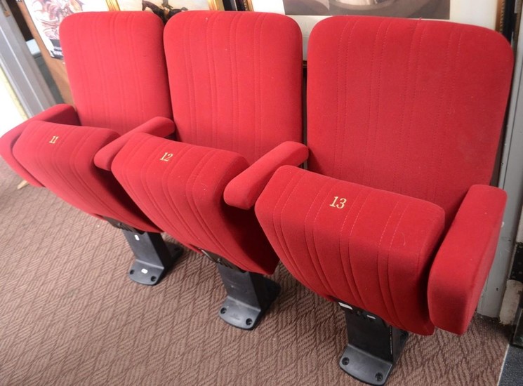 Three folding cinema seats. Numbered 11, 12 and 13 from a lo...