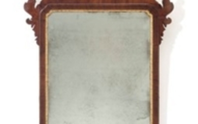 A CHIPPENDALE MAHOGANY-VENEERED AND PARCEL-GILT LOOKING GLASS, ENGLISH OR AMERICAN, 1760-1780