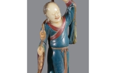 A Chinese soapstone figure of a Liuhai holding a string of money
