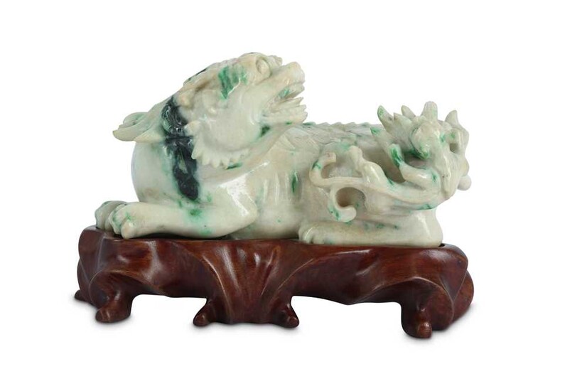 A CHINESE APPLE-GREEN JADEITE CARVING OF A QILIN.