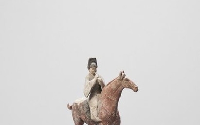 A COLD PAINTED TERRACOTTA MODEL OF A HORSE...