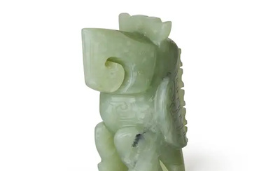 A Chinese archaistic green jade standing parrot 20th century With stylised scrolling...