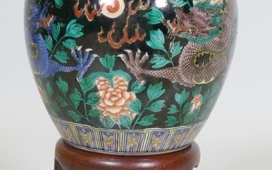 A Chinese famille noir jar with dragon decoration and...