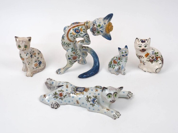 A French faience cat by Fourmaintraux, Desvres, c.1910, modelled in a jaunty pose and decorated with blossoming flowers, with green glass eyes, hand-painted signature JC and numbered 33 to underside, 20.8cm high, together with a Mosanic Gallé style...