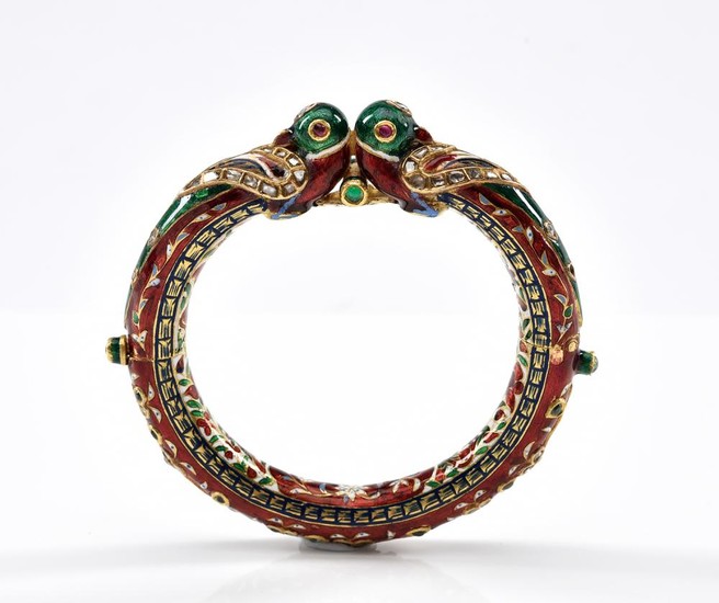 A GOLD, ENAMEL AND DIAMOND BANGLE-Of Eastern design set with red, green and blue enamel, with mine cut diamond detail, in 18ct gold.