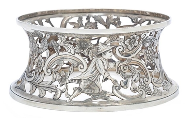 A George III silver dish ring, apparently unmarked, probably Irish, c.1760, pierced and engraved with exotic birds, a dolphin and a farmhand amidst foliate scrolls and fruit, base 20.4cm diameter, 9cm high, approx. weight 13.7oz Provenance: Lot...