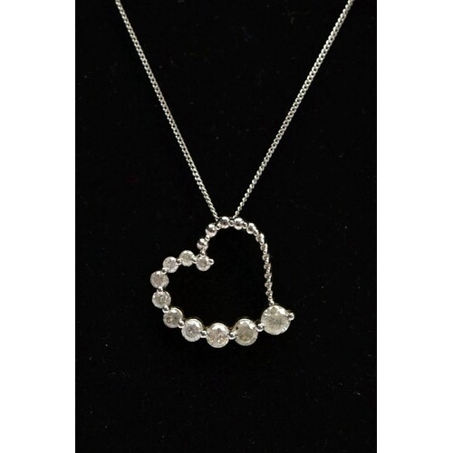 A MODERN 9CT WHITE GOLD DIAMOND HEART AND CHAIN, a witch's g...