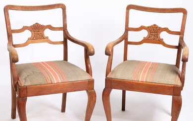 A PAIR OF CARVED OAK OPEN ARMCHAIRS.