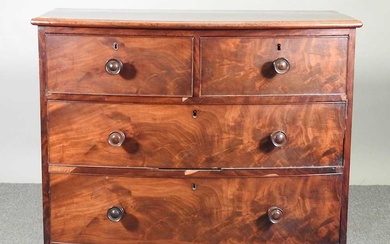 A Victorian mahogany bow front chest of drawers, on turned...