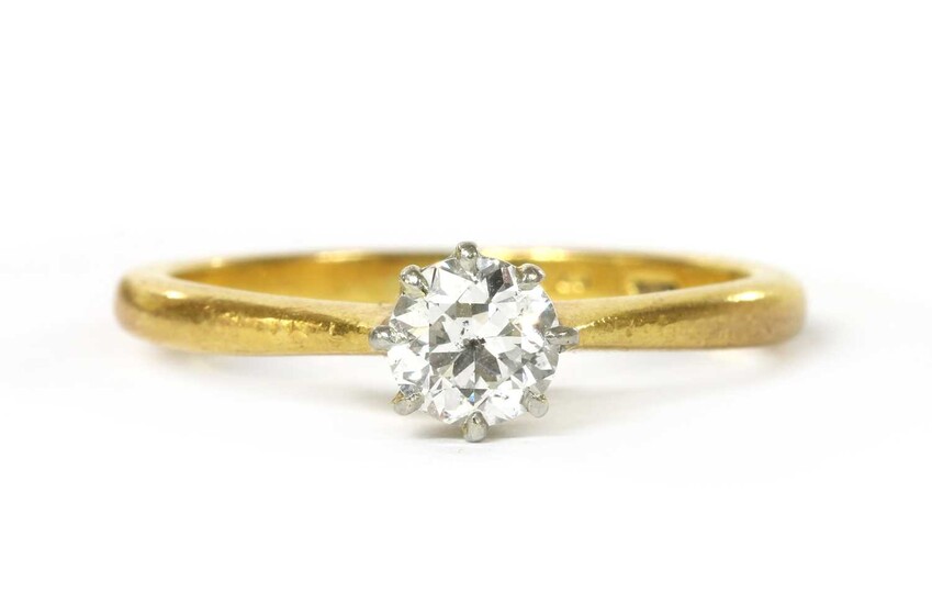 A gold single stone diamond ring