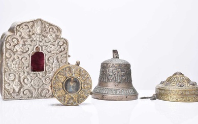 A group of Tibetan prayer boxes and a prayer bell