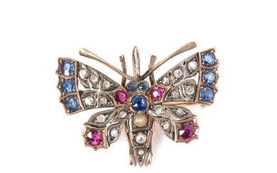 A late 19th century England gold/silver pendant/brooch, faceted sapphires and rubies, oriental pearls, and rose cut diamonds.