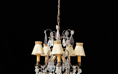 A mid-20th century Rococo chandelier, 5-arm, brass frame, hinged with prisms, electrified.