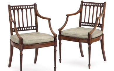 A pair of English mahogany armchairs with cane seats, later cushions upholstered...