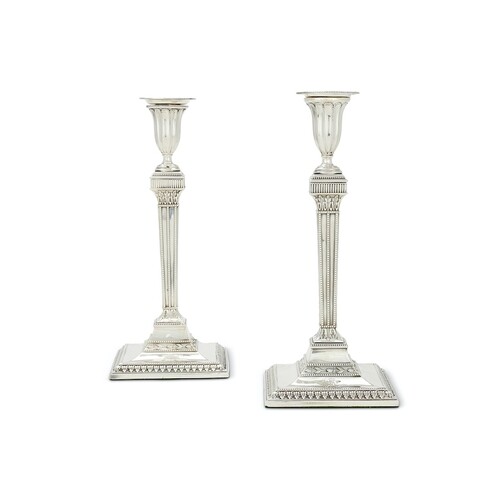 A pair of George III silver candlesticks of neo-classical fo...