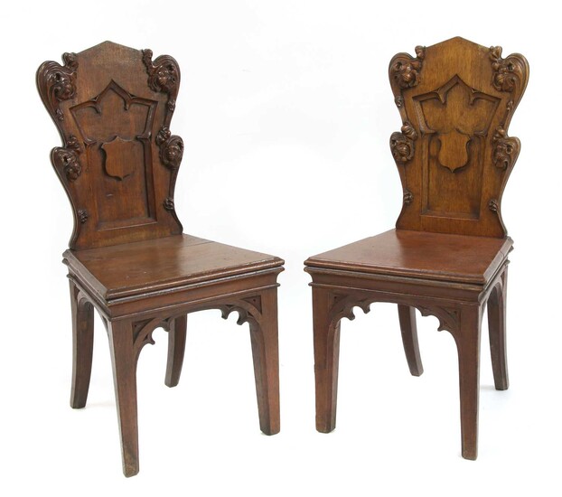 A pair of Victorian oak Gothic hall chairs