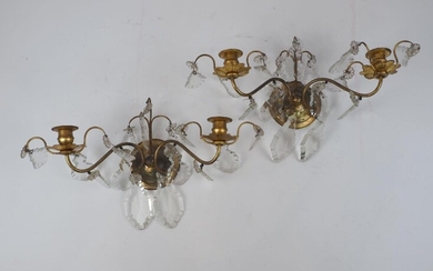 A pair of brass twin-light wall appliques, late 20th century, each hung with facetted glass drops, 23cm high, 38cm wide (2)