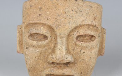 A pre-Columbian Teotihuacan style carved buff hardstone mask, probably 250-700 AD, with pierced hole