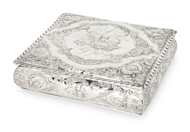 A putti-decorated Victorian silver jewellery box, Birmingham, 1898, Henry Matthews, of rectangular form, with crimped edge, the hinged lid and sides richly repousse decorated with putti, floral and scroll motifs, the interior with red velvet...