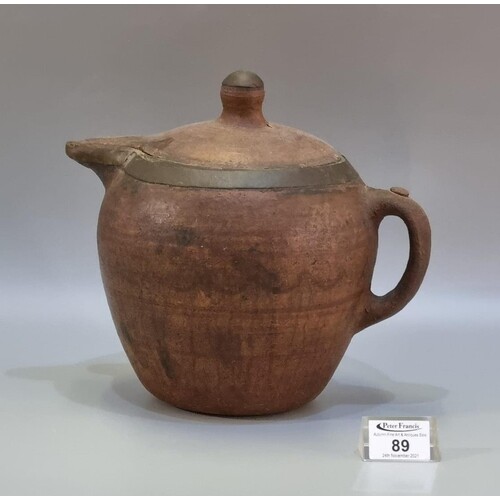 A rustic terracotta baluster shaped teapot or jug with paint...