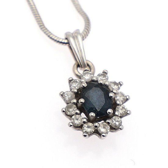 A sapphire and diamond pendant set with an oval-cut sapphire encircled by numeros single-cut diamonds, mounted in 14k gold. Accompanied by a 18k gold necklace.